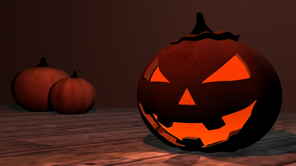 Image of a jack-o-lantern and two pumpkins in the background.