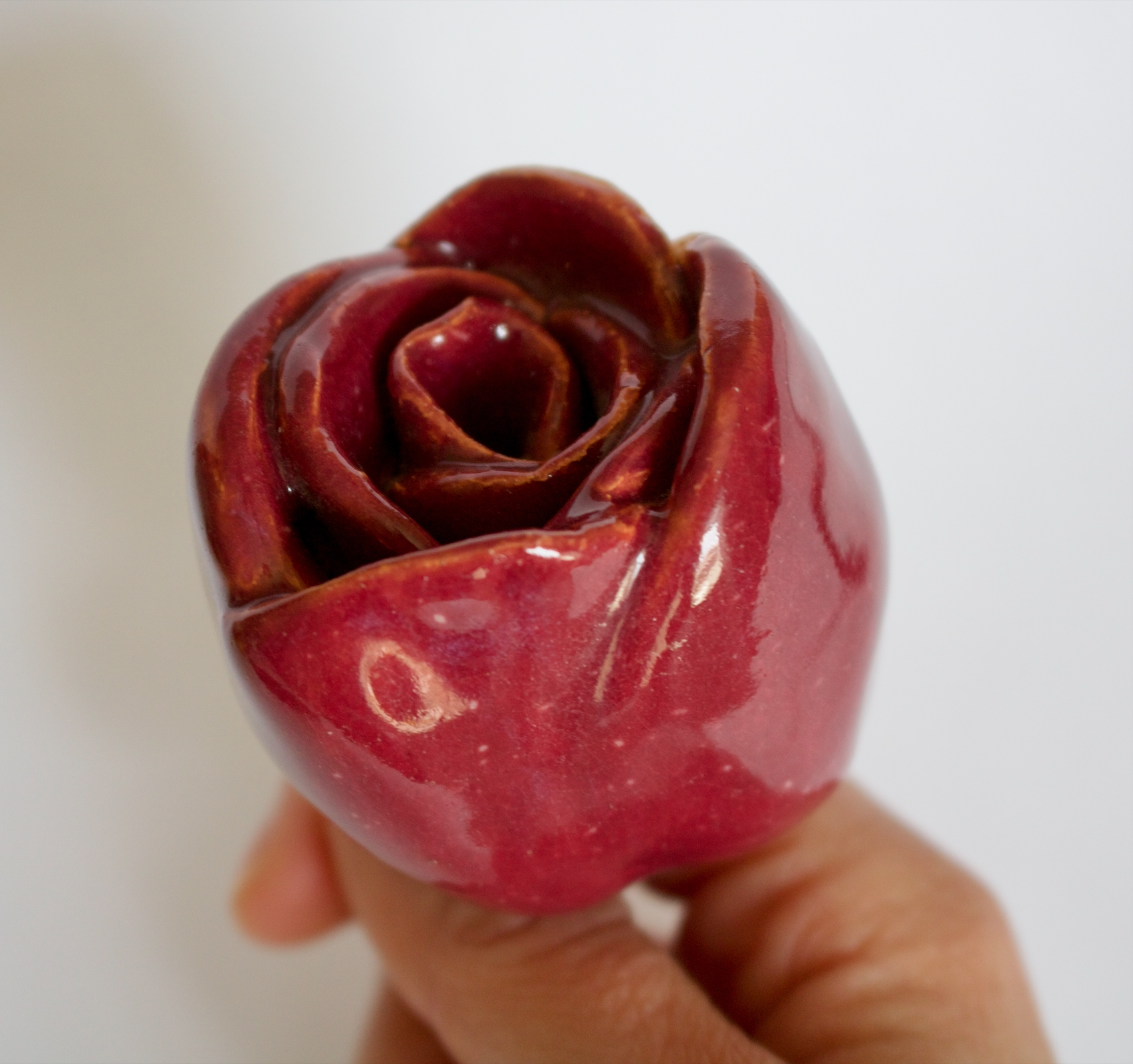 A red ceramic rose.